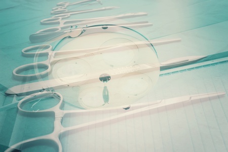 Close Up Surgical Instruments on the Green Fabric with Surgical Lamp in the Background, Double...