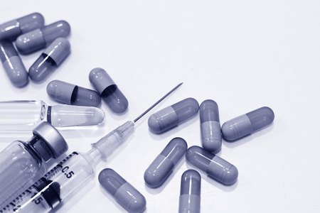 3 ml Plastic Syringe with Needle, Vial, Ampule of Drug and Drug Capsules Isolated on the White Backgroundの写真素材