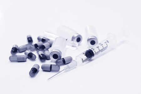 Vial of Drug, 3 ml Plastic Syringe with Needle and Drug Capsules Isolated on the White Backgroundの写真素材