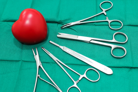 Surgical Instruments and rubber heart on the Medical Green Fabricの写真素材