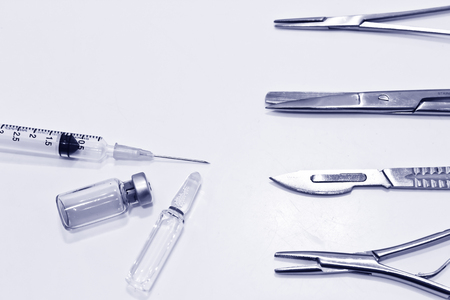 Medical Concept, The Surgical Instruments,  Vial and ampule of Drug, 3 ml Plastic Syringe with Needle Isolated on the White Backgroundの写真素材