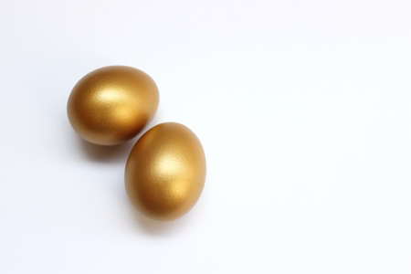 The golden eggs isolated on the white backgroundの写真素材
