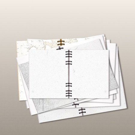Stack of open notebooks on gray background 
