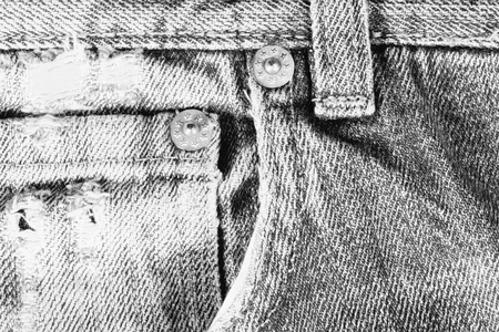 Old frayed blue jeans closeup