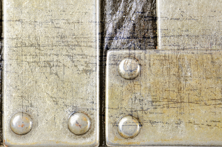 Scratched metal plate on black leather background texture