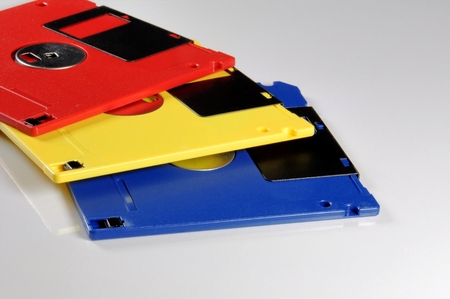 Old color floppy disk. Red, yellow and blue.の写真素材