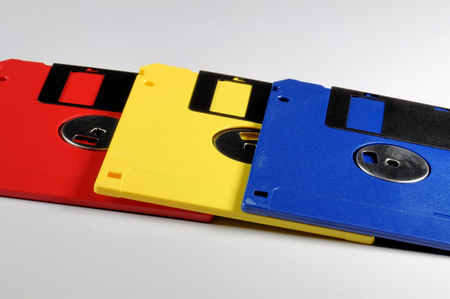 Old color floppy disk. Red, yellow and blue.の写真素材