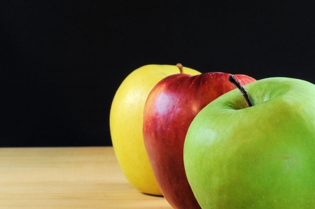 Three apples on black background. Selective focus.の写真素材