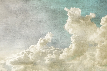 Blue sky with white clouds in retro grunge style. Nature background.の写真素材