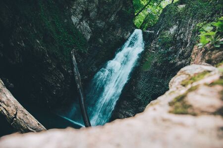 In a mountain forest, a waterfall in a gorgeの写真素材