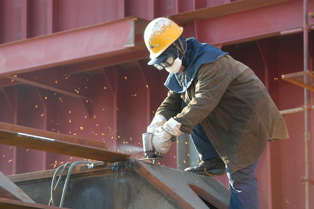 Shipbuilders in the grinding of weldの写真素材