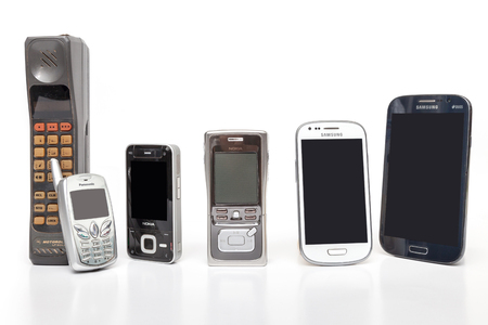 THAILAND - JANUARY 25, 2016 : Old and New Design Mobile Phone on white background.