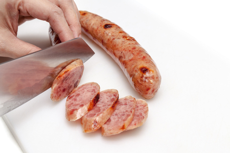 Chef slice chinese sausage into small piecesの写真素材
