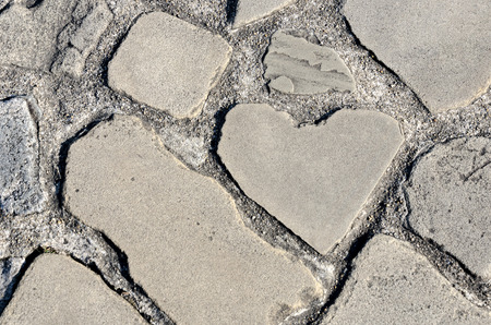Heart shaped rock on the ground in the parkの写真素材