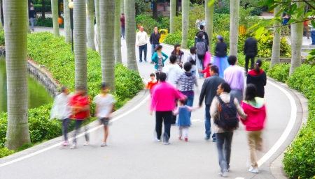 People are walking   taking exercise on the road  Enjoys the sunlight at the afternoon 