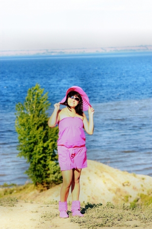 Attractive young girl on a background of waterの写真素材