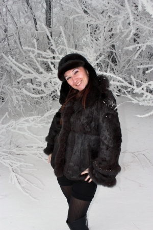 Girl in a snowy winter forestの写真素材