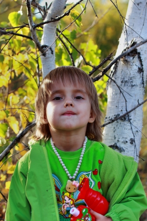 The four-year girl in the autumn forestの写真素材
