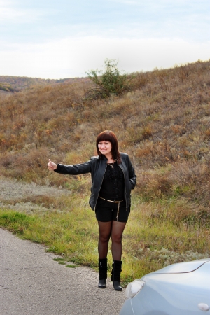Cute young girl catches a taxiの写真素材