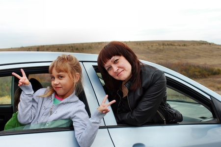 Mother and daughter look out of the carの写真素材