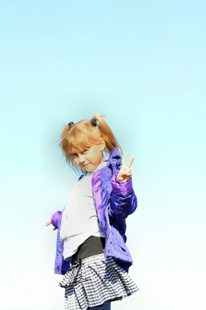 The little girl on a background of blue skyの写真素材