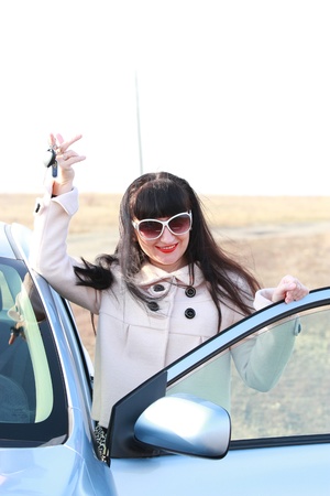 Young happy brunette with a car keyの写真素材