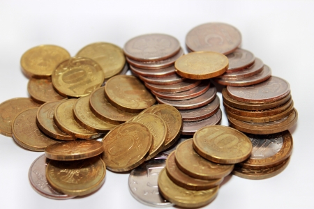 Scattering of coins on white backgroundの写真素材