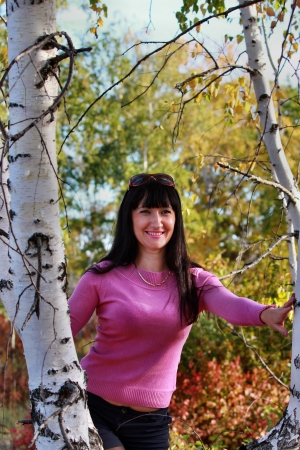 Beautiful girl in the autumn forest near birchesの写真素材