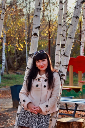 Smiling girl near birches in the Children's Parkの写真素材
