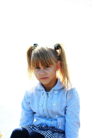 Portrait of a sad girl on a white backgroundの写真素材
