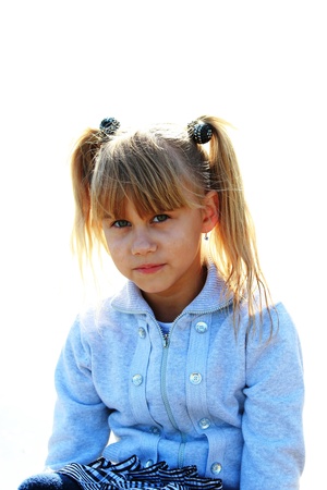 Portrait of a serious little girl in a blue jacketの写真素材