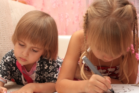 Girls sister paint pens lying on the couchの写真素材