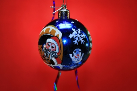 Christmas tree decoration ball on a red backgroundの写真素材