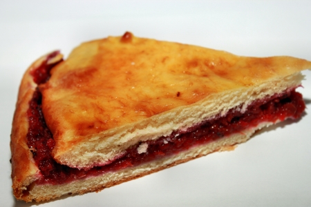 A piece of strawberry cake on a white backgroundの写真素材