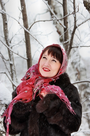 Young woman in winter forest dreams look upwardsの写真素材