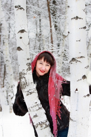 Girl near a birch forest in winterの写真素材