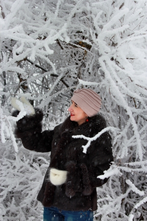 The girl in the frosty winter forestの写真素材