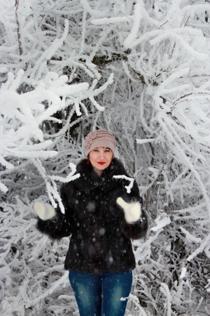 Girl in winter forest in a snowy treeの写真素材