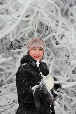 Girl among the snow-covered treeの写真素材