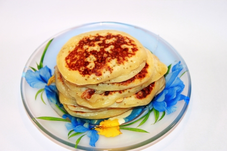 Sweet pancakes with honey on a plateの写真素材