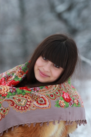 Portrait of a young brunette in a beautiful scarfの写真素材