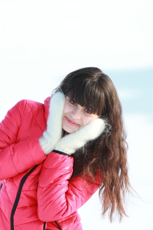 Young girl in white mittens in the fresh airの写真素材