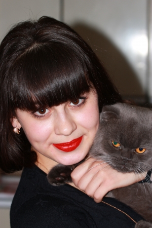 Portrait of a young girl with a British cat in her armsの写真素材