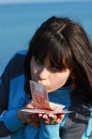 The girl kisses the five thousandth billsの写真素材