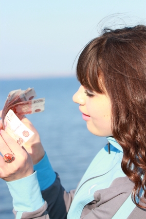 Young woman counting moneyの写真素材