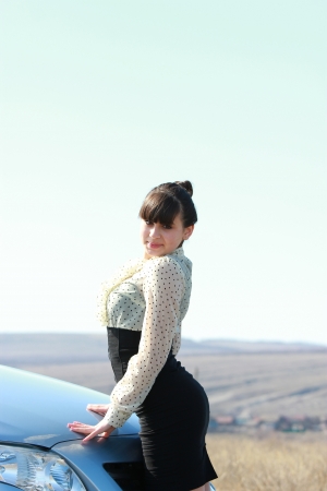 Young beautiful girl outdoor near the carの写真素材