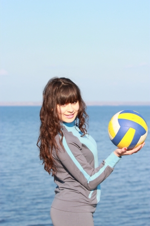 Young brunette holding a ballの写真素材