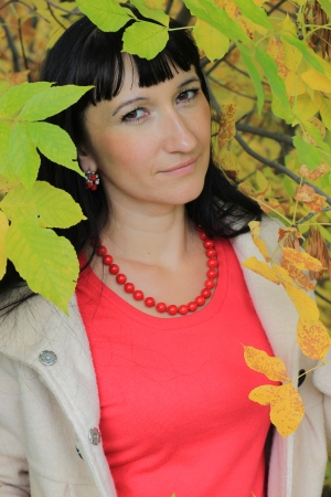 Portrait of a beautiful woman among the autumn leavesの写真素材