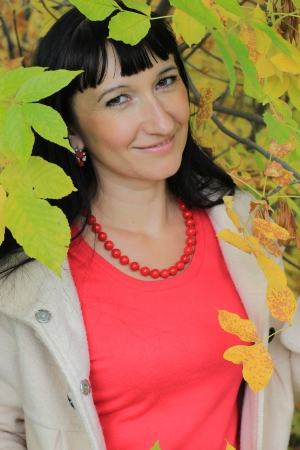 Portrait of a young woman among the autumn leavesの写真素材