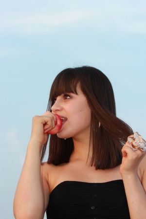 Girl biting red juicy appleの写真素材
